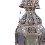 A Moroccan pierced brass lantern with coloured glass panels, height 50cm