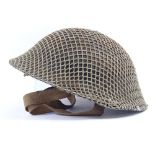 A Second War Period British Army Brodie steel helmet, with original Commando mesh webbing and canvas