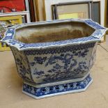 A large Chinese blue and white painted jardiniere, with bird and floral decoration, and shaped