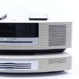 A Bose Wave music system and CD player, with remote controls