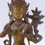 A Chinese patinated bronze deity, seated on lotus base with engraved signature, height 22cm