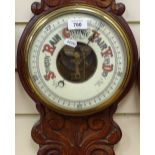 A Victorian carved oak-cased aneroid wall barometer and thermometer, with ceramic dials, height 80cm