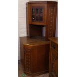 An Edwardian oak 2-section corner cabinet of stylised form, H166cm