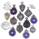 A collection of silver fobs, including some enamel