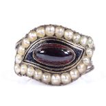 A 19th century unmarked rose gold high cabochon garnet, split pearl and black enamel mourning