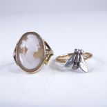 An early 20th century unmarked gold relief carved shell cameo panel ring, size N, 3g, and an
