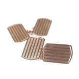 A pair of 10ct rose gold curved rectangular panel cufflinks, engine turned decoration, panel