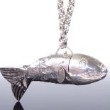 An unusual Continental unmarked white metal articulated fish pendant, on heavy English silver