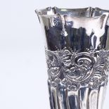 A late Victorian silver flower vase, tapered cylindrical form with half-fluted foliate decoration,