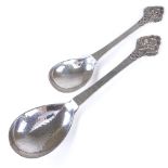 EVALD NIELSEN - a Vintage graduated pair of Danish stylised silver spoons, relief floral