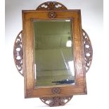 An early 20th century oak-framed wall mirror, with carved and pierced mounts, overall dimensions