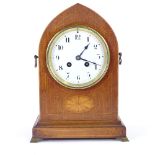 A French mahogany lancet-top 8-day mantel clock, satinwood inlay with brass mounts and white