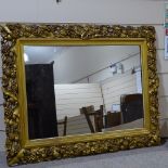 A large Victorian gilt-gesso framed wall mirror, with fruit decorated surround, overall dimensions