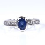 A modern 18ct white gold sapphire and diamond dress ring, total diamond content approx 0.15ct,