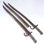 A pair of 19th century sword bayonets with metal scabbards