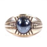 A large 9ct gold cabochon haematite and paste signet ring, setting height 13.1mm, size X, 6.9g