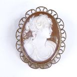 A relief carved shell cameo panel brooch, depicting female bust, in 9ct gold frame, overall height