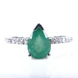 A 14ct white gold solitaire emerald ring, with diamond set shoulders, pear-cut emerald approx 1.