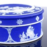 A Wedgwood blue Jasper circular pot and cover, diameter 8.5cm The base has a chip on the inside rim,