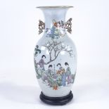 A Chinese porcelain vase, hand painted figures in gardens, with pierced gilded handles, base