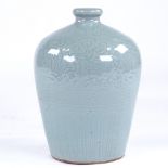 A Chinese celadon glaze bottle vase with incised decoration, height 22cm Perfect condition