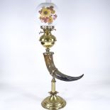 A brass and buffalo horn oil lamp, with opaque glass shade, height to top of shade 75cm