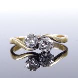 A late 20th century 18ct gold 2-stone diamond cross-over ring, total diamond content approx 0.6ct,