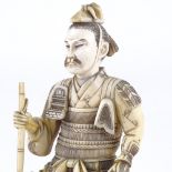 A Japanese ivory carving of a Samurai Warrior, Meiji Period, signed with lacquer seal under base,