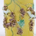 A Chinese yellow glaze porcelain cylinder vase, high relief decorated squirrels and acorns, height