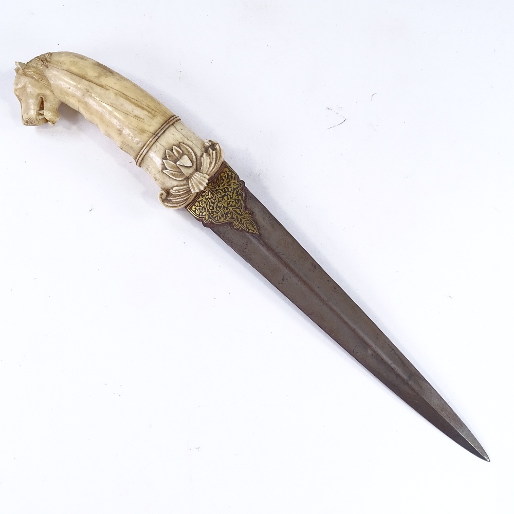 A Middle Eastern dagger, 18th or 19th century, the carved ivory handle having a leopard's head