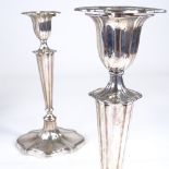 A pair of George V silver table candlesticks, shaped oval form with tapered stick, reeded border and