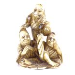 A 19th century Japanese ivory netsuke, depicting 3 figures, signed, height 5cm