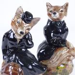 A pair of Staffordshire China hunting foxes in black coats, height 19cm Perfect condition