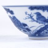 A Chinese blue and white porcelain bowl, with hand painted bats and blossom trees, 6 character mark,