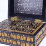 A 19th century ebony and porcupine quill box, with inlaid ivory discs and fitted interior, width