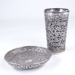 An Indian unmarked white metal dish, and a similar cocktail shaker case, all-over relief and