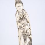 A large Chinese carved ivory standing figure holding lotus flowers, early 20th century, height