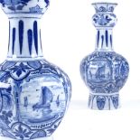 A pair of Delft blue and white glaze narrow-neck vases, with harbour scenes, height 27cm, late