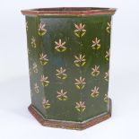 A painted wood waste paper bin of octagonal form, painted flowers on green ground, height 38cm, 33cm