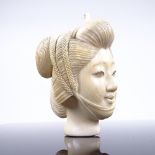 A Japanese ivory carving, head of a woman, Meiji Period circa 1900, height 7cm