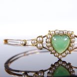 A Victorian unmarked gold green stone and pearl heart-shaped hinged bangle, with openwork body,