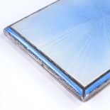 A George VI rectangular silver and blue enamel cigarette case, with engine turned decoration and
