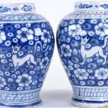 A pair of Continental blue and white tin glaze pottery vases, late 18th/early 19th century, height