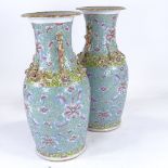 A pair of Chinese porcelain vases, with painted enamel decoration and gilded dragon necks, height