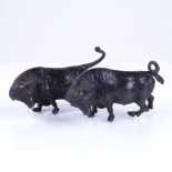 A pair of miniature patinated bronze bulls, length 10cm Legs bent and horns missing