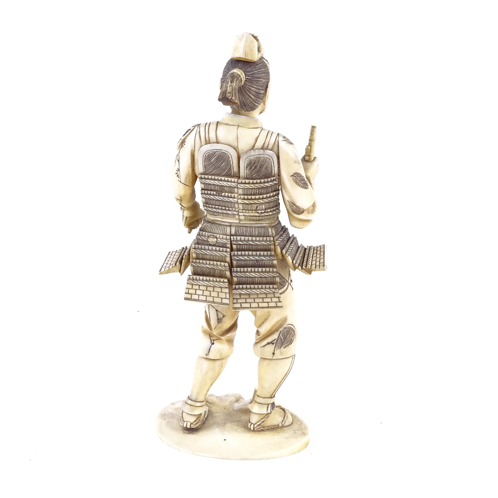 A Japanese ivory carving of a Samurai Warrior, Meiji Period, signed with lacquer seal under base, - Image 3 of 4