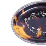 A 19th century oval tortoiseshell dish, with inlaid mother-of-pearl and silver floral marquetry,