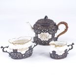 A Victorian silver-cased 3-piece ceramic tea set, pierced and embossed silver mounts, by William