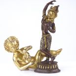 An Indian parcel gilt-bronze dancing Buddha, height 20cm, and a gilt-bronze seated cherub (2)