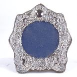 An Elizabeth II silver-fronted photo frame, relief embossed cherub and foliate decoration, by